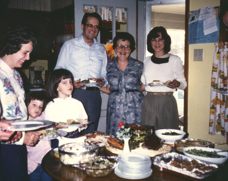 Picture of family around a loaded table